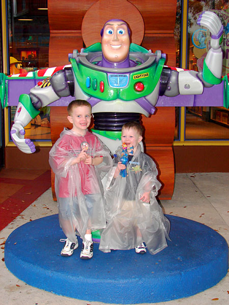 Jacob and Andrew in rain ponchos with Buzz Lightyear (112.13 KB)