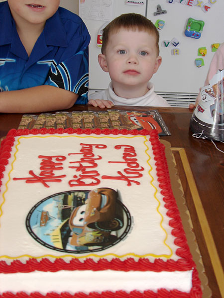 Andrew surveying his birthday cake (93.11 KB)