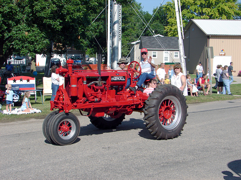 My brother-in-law with his dad driving his antique tractor (339.74 KB)