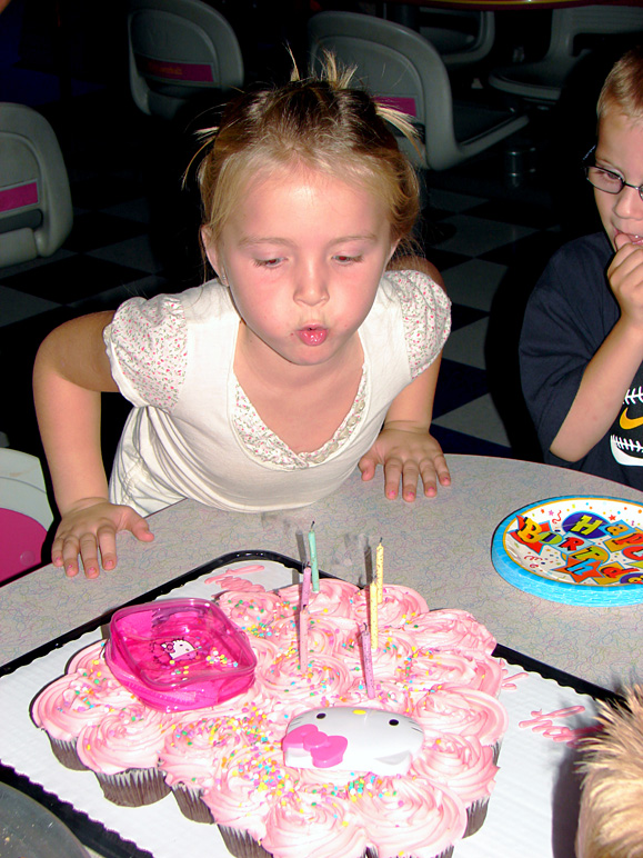 Mackenzie blowing out her candles (251.21 KB)