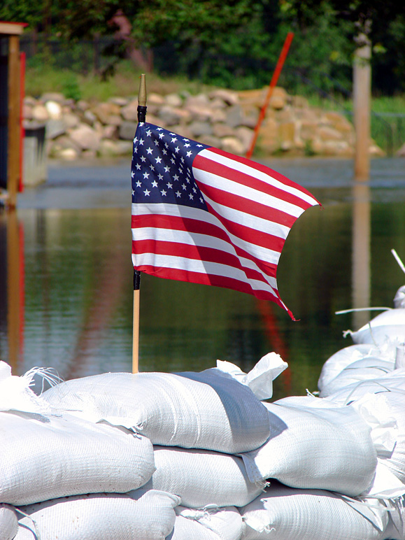 Flag in a sandbag levee (219.94 KB)