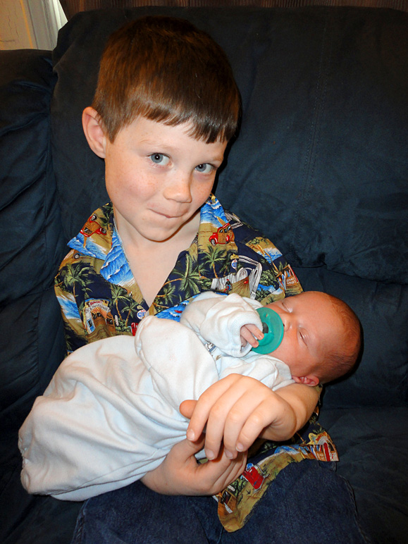 Andrew holding his new little brother (207.71 KB)