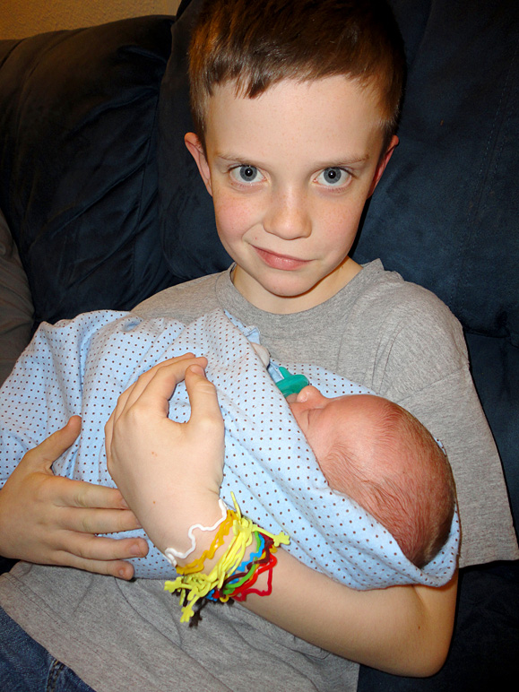 Jacob holding his new little brother (225.52 KB)