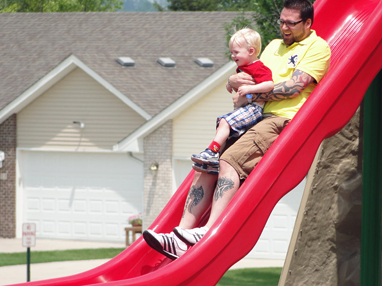 Ryan going down a slide with Marshall on his lap (187.29 KB)